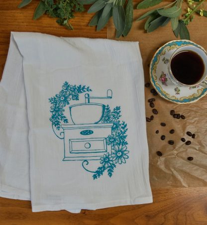 white cotton tea towel with vintage coffee grinder screen printed in teal ink