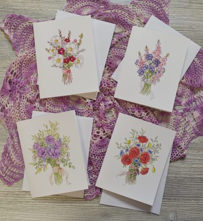 four cards with different pen and ink and watercolor floral bouquets