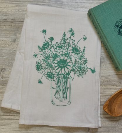 tea towel with jar of zinnia flowers