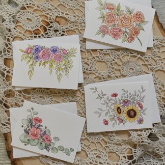 four miniature cards with flowers on them