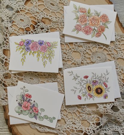 four miniature cards with flowers on them